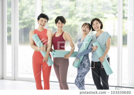 Four women with yoga mats Four women with yoga mats 103830680