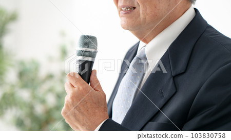A man who speaks with a microphone Senior A man who speaks with a microphone Senior 103830758