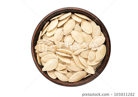 White pumpkin seeds in a plate, top view. Isolated on white background. White pumpkin seeds in a plate, top view. Isolated on white background. 103831282