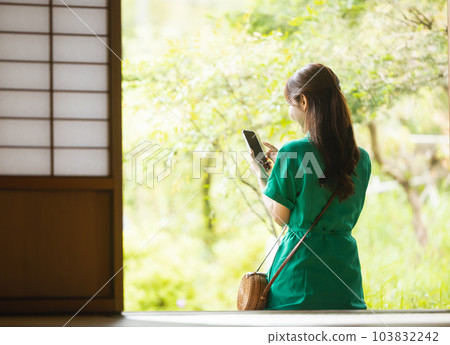 Woman operating a smartphone 103832242