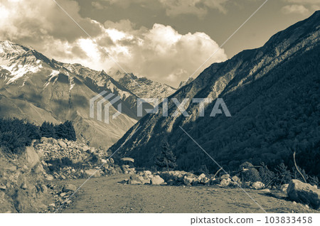 Grey Color Mountain Valley landscape with flying clouds in the background. Nature Wallpaper. Grey Color Mountain Valley landscape with flying clouds in the background. Nature Wallpaper. 103833458