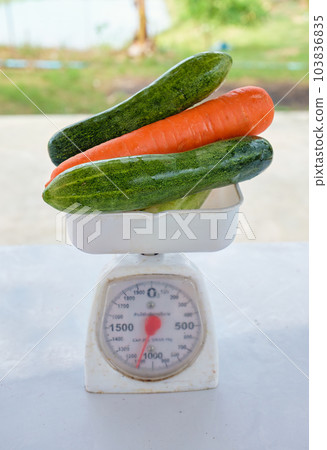 Fruit and vegetable on weight scale Fruit and vegetable on weight scale 103836835