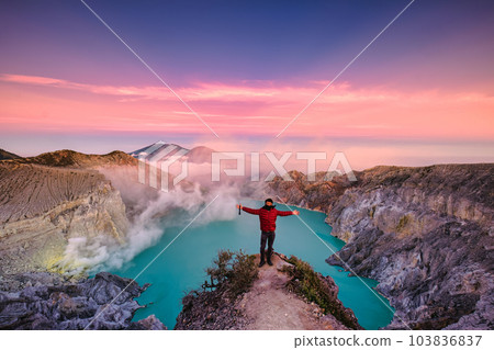 Traveler man standing on the crater of Kawah Ijen volcano with sunrise sky in the morning Traveler man standing on the crater of Kawah Ijen volcano with sunrise sky in the morning 103836837