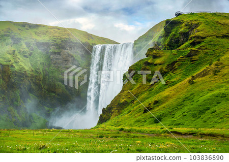 Scenery of Lush Skogafoss waterfall flowing in summer at Iceland 103836890
