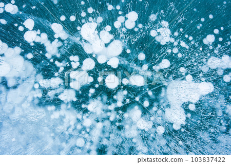 Natural ice bubbles on frozen lake in wintertime Natural ice bubbles on frozen lake in wintertime 103837422