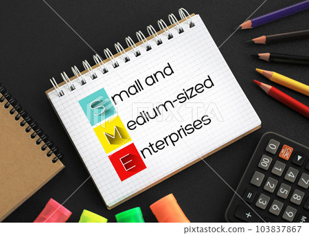 SME Small And Medium-sized Enterprises - businesses whose personnel numbers fall below certain limits, acronym text concept background on notepad 103837867