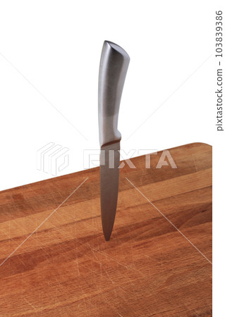 Knife stuck in cutting board Knife stuck in cutting board 103839386