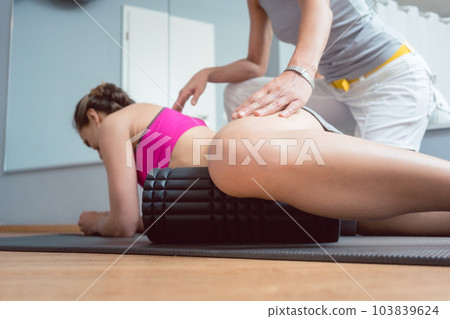Woman stretching and relaxing in physical therapy exercise 103839624