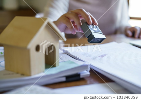 Approved stamp with Business people signing contract making deal with real estate consultant home insurance.Real estate investment Property insurance security offer house. 103840359