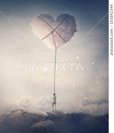 Romantic view of a young man, holding a lasso, trying to catch and pull a heart shaped cloud from the sky. Magical scene, love and romance concept Romantic view of a young man, holding a lasso, trying to catch and pull a heart shaped cloud from the sky. Magical scene, love and romance concept 103842344