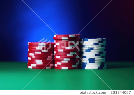 Casino tokens or casino poker chips stack on green table, colorful blur background. Generative AI Casino tokens or casino poker chips stack on green table, colorful blur background. Generative AI 103844067