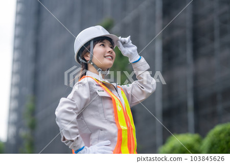 Young woman in helmet working at construction site Young woman in helmet working at construction site 103845626