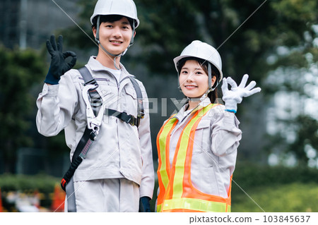Young men and women working at building construction site Young men and women working at building construction site 103845637