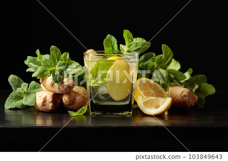 Cold refreshing drink with ice, ginger, lemon, and mint. Cold refreshing drink with ice, ginger, lemon, and mint. 103849643