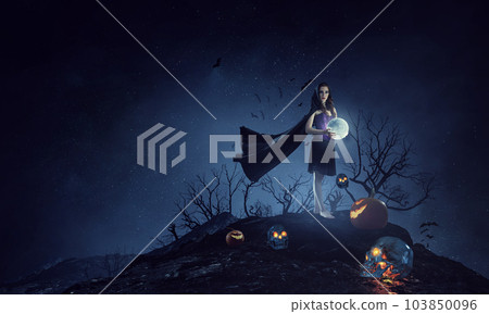 Beautiful young woman in witches hat and costume 103850096