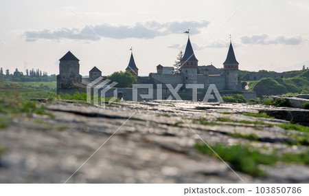 Stone walls with Kamianets-Podilskyi castle in the background, Ukraine. Stone walls with Kamianets-Podilskyi castle in the background, Ukraine. 103850786