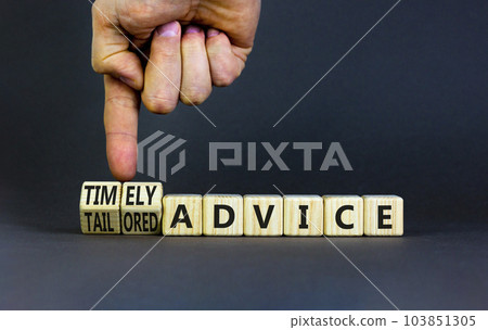 Timely or tailored advice symbol. Concept words Timely advice and Tailored advice on wooden cubes. Businessman hand. Beautiful grey background. Business timely or tailored advice concept. Copy space. 103851305
