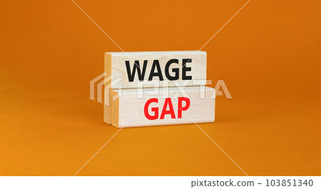 Wage gap symbol. Concept words Wage gap on wooden blocks on a beautiful orange table orange background. Business, support and wage gap concept. Copy space. Wage gap symbol. Concept words Wage gap on wooden blocks on a beautiful orange table orange background. Business, support and wage gap concept. Copy space. 103851340