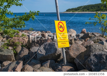 Next to the river bank. No swimming sign. Risk of drowning to warn the public 103851356