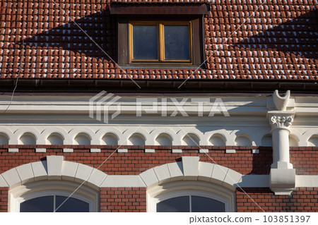 A small section of the roof and cornice of a historic neo-Gothic-style building. 103851397