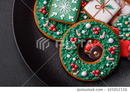 Delicious fresh colorful Christmas or New Year gingerbread cookies Delicious fresh colorful Christmas or New Year gingerbread cookies 103852138