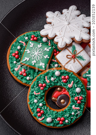 Delicious fresh colorful Christmas or New Year gingerbread cookies Delicious fresh colorful Christmas or New Year gingerbread cookies 103852139