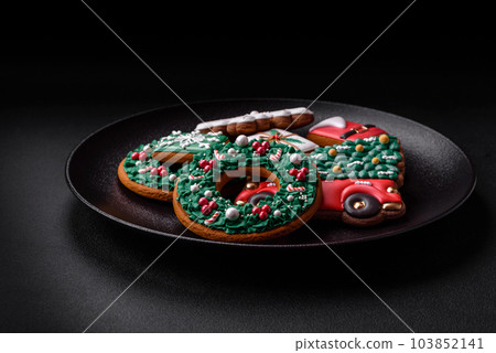 Delicious fresh colorful Christmas or New Year gingerbread cookies Delicious fresh colorful Christmas or New Year gingerbread cookies 103852141