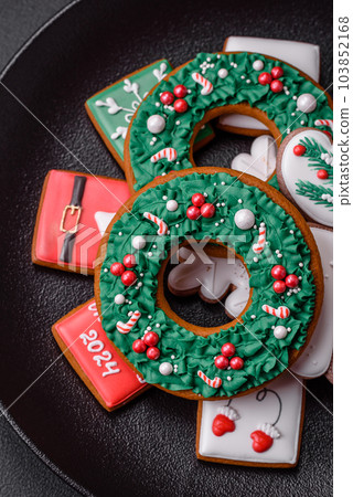 Delicious fresh colorful Christmas or New Year gingerbread cookies Delicious fresh colorful Christmas or New Year gingerbread cookies 103852168