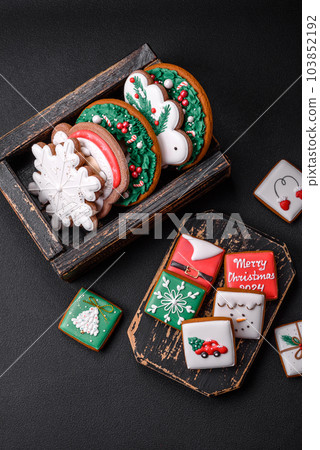 Delicious fresh colorful Christmas or New Year gingerbread cookies Delicious fresh colorful Christmas or New Year gingerbread cookies 103852192
