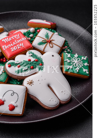 Delicious fresh colorful Christmas or New Year gingerbread cookies Delicious fresh colorful Christmas or New Year gingerbread cookies 103852225