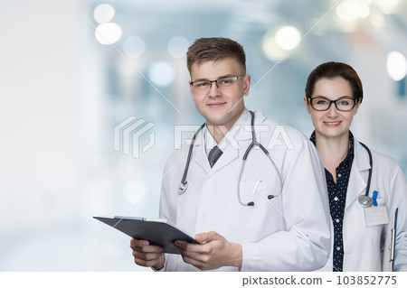 Doctors stand on a background. 103852775