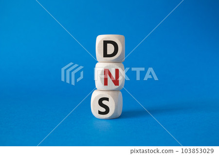 DNS -Domain Name Server - Consumer Price Index symbol. Concept word DNS on wooden cubes. Beautiful blue background. Business and DNS concept. Copy space. 103853029