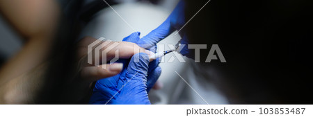 Manicurist doing hardware manicure to woman using special apparatus Manicurist doing hardware manicure to woman using special apparatus 103853487