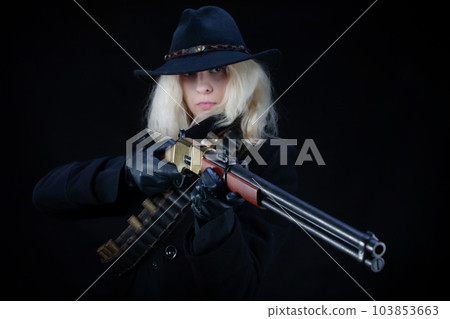 Old west blonde girl in black hat with gun Old west blonde girl in black hat with gun 103853663