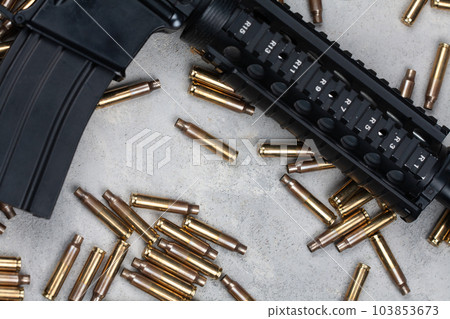 M4 carbine and 5.56mm shells and magazine with bullets M4 carbine and 5.56mm shells and magazine with bullets 103853673