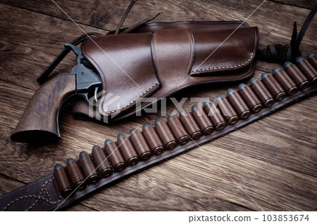 Old west leather gun belt with ammnunitions and revolver in holster Old west leather gun belt with ammnunitions and revolver in holster 103853674