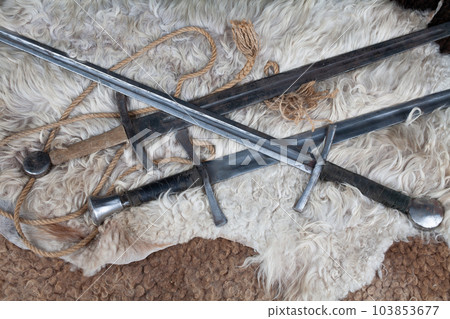 Medieval swords on sheep fur Medieval swords on sheep fur 103853677