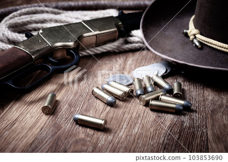 Old west rifle, ammunition and cowboys hat Old west rifle, ammunition and cowboys hat 103853690