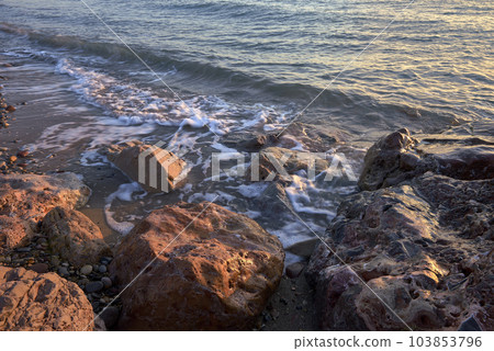 Line of stones from the coast at sunrise 103853796