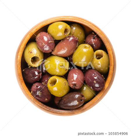 Pitted Kalamata and green olives, in a wooden bowl. Mix of organic Greek olives, green and black, with herbs, preserved in native olive oil. Popular table olives, used as snack, appetizer or garnish. 103854906
