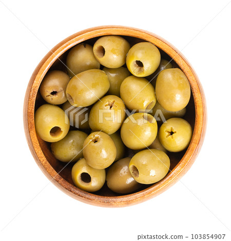 Pitted green olives, in a wooden bowl. Organic olives from Italy. Picked as semi-ripe and turning-color olives, with reddish-green color, preserved in salt. Used as a snack, appetizer or as garnish. 103854907