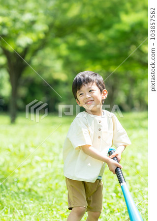 boy playing ball in the park boy playing ball in the park 103857562