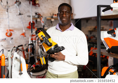 Man with drainline pump in store Man with drainline pump in store 103858452