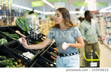 Cheerful woman choosing mushrooms 103858619