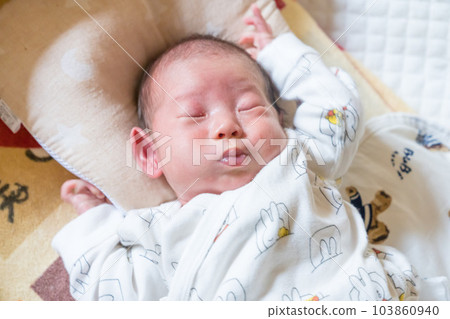 Baby sleeping in a cot Baby sleeping in a cot 103860940