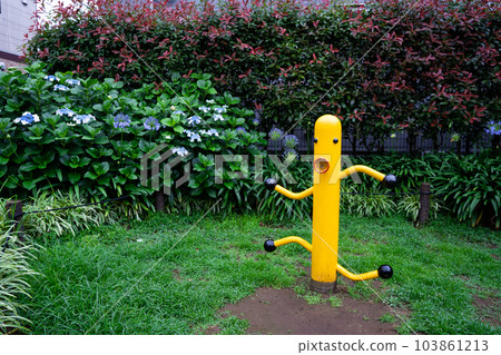 Mysterious yellow playground equipment and hydrangeas in the park Mysterious yellow playground equipment and hydrangeas in the park 103861213