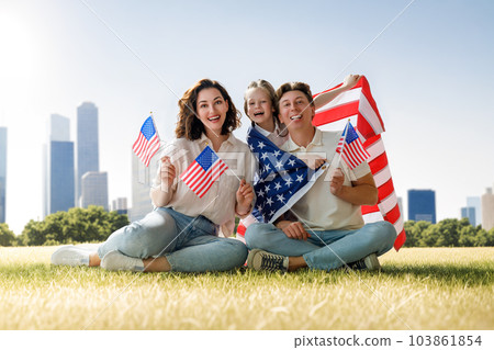 Patriotic holiday, family with American flag 103861854