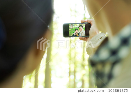 photo of man and woman taking a selfie 103861875