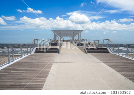 Wood deck extending to the sea 103863502