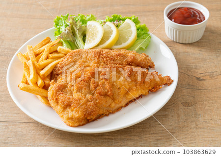 Homemade Breaded Weiner Schnitzel with Potato Chips Homemade Breaded Weiner Schnitzel with Potato Chips 103863629